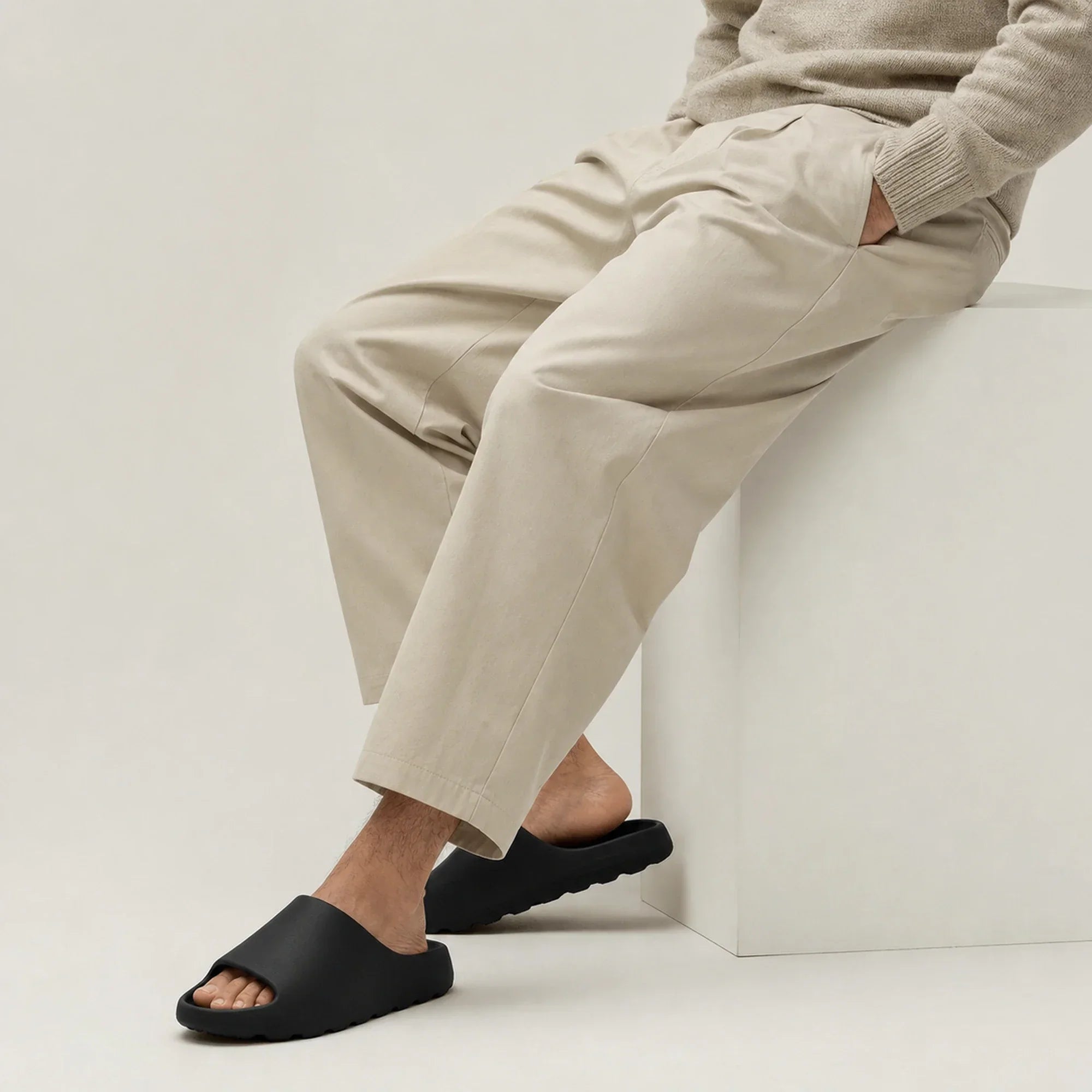 Black EVA platform slide slippers worn while seated