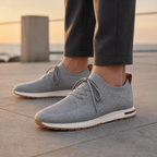 Men's gray knit sock-fit sneakers on a modern promenade