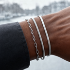 Close editorial view of three layered silver bracelets